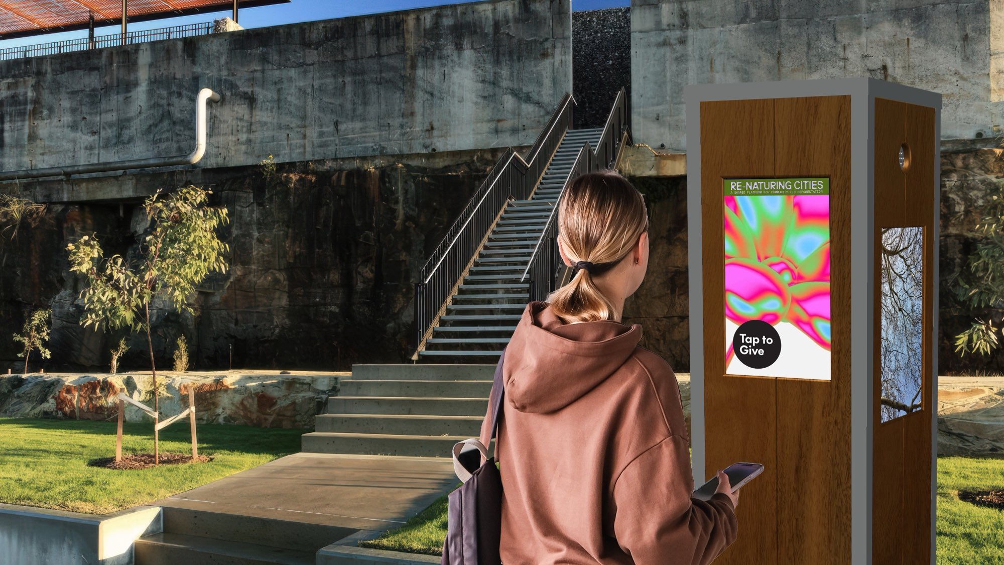 A person at a STORYBOX Post in a public park, with 'Tap to Give' on screen